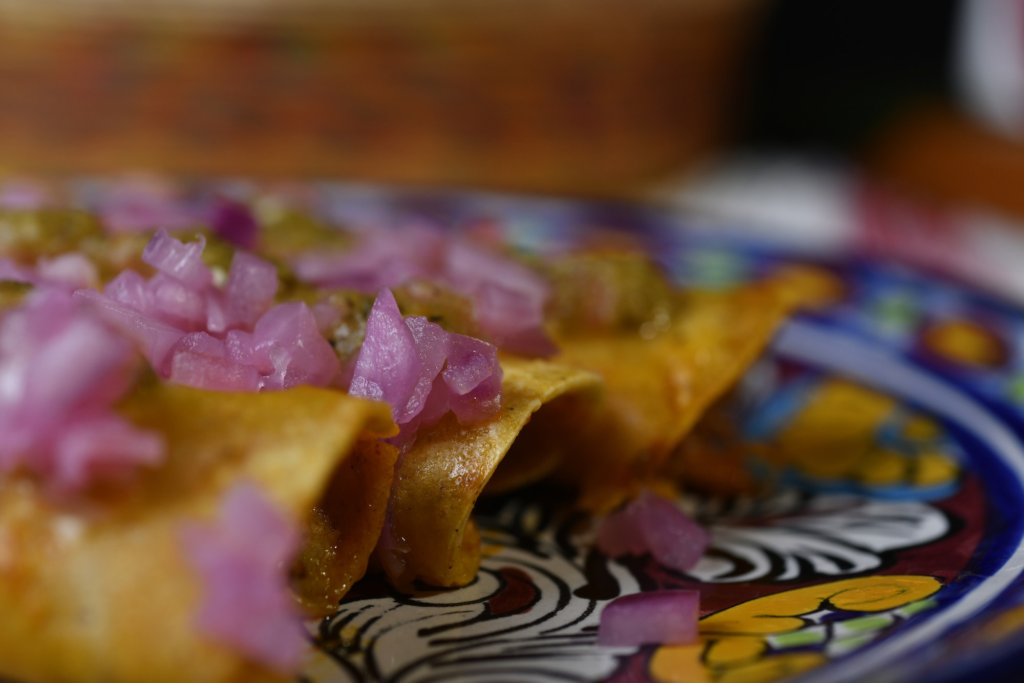 Cochinita pibil tacos, with tortillas, seasoned pork, purple onion, and habanero pepper